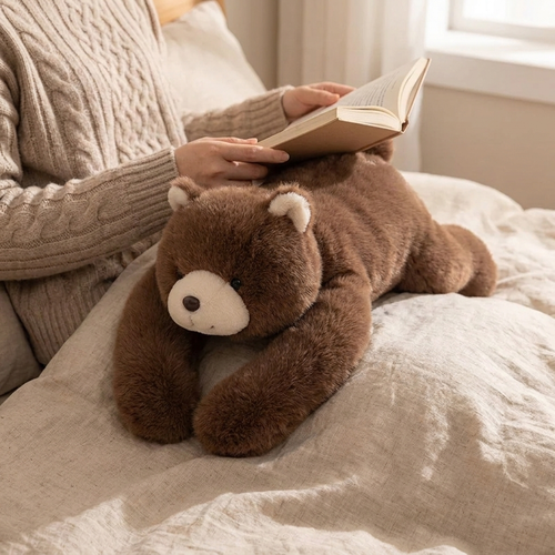 Huggo Weighted Bear lying across a lap during evening reading — weighted bear plush